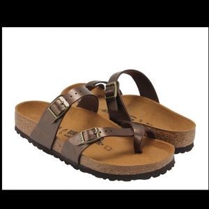Brown four toe Birkenstock sandals.